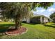 Expansive backyard featuring a lush lawn, mature trees, and an enclosed patio, perfect for outdoor relaxation at 5604 Gulf Stream St, Tavares, FL 32778