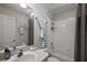 Bright bathroom features a shower-tub combination and decorative sailboat, creating a nautical atmosphere at 5604 Gulf Stream St, Tavares, FL 32778
