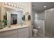 Bathroom featuring double sinks, modern lighting, and a glass-enclosed shower at 5604 Gulf Stream St, Tavares, FL 32778
