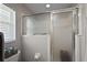 Bathroom featuring a frosted-glass shower enclosure and gray tiled walls at 5604 Gulf Stream St, Tavares, FL 32778