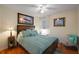 Cozy bedroom with hardwood floors, comfortable furniture, and plenty of natural light at 5604 Gulf Stream St, Tavares, FL 32778