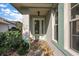 Inviting front entrance with decorative glass door, stone tile, and lush landscaping at 5604 Gulf Stream St, Tavares, FL 32778