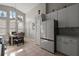 Bright kitchen with stainless steel appliances, tiled floor, and adjacent dining area at 5604 Gulf Stream St, Tavares, FL 32778