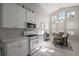 Well-lit kitchen with white cabinetry, modern appliances, and eat-in dining area at 5604 Gulf Stream St, Tavares, FL 32778