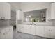 Kitchen featuring white cabinets and a view into the living room at 5604 Gulf Stream St, Tavares, FL 32778