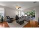 Spacious living room featuring hardwood floors, a ceiling fan, and sliding glass doors leading to the lanai at 5604 Gulf Stream St, Tavares, FL 32778