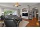 Comfortable living room with hardwood floors, ceiling fan, and large windows showcasing the backyard at 5604 Gulf Stream St, Tavares, FL 32778