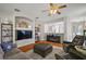 Bright living room with hardwood floors, TV, decorative archways, and open view into the kitchen at 5604 Gulf Stream St, Tavares, FL 32778