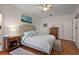 Comfortable main bedroom with a large bed, wooden floors, and neutral decor at 5604 Gulf Stream St, Tavares, FL 32778