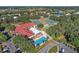 Aerial view of the community center showcasing a pool, tennis courts, and well-maintained green spaces at 5618 Rosewall Cir, Leesburg, FL 34748