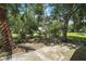 Lush backyard with mature trees and patio, creating a private outdoor living space at 5618 Rosewall Cir, Leesburg, FL 34748