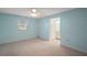 Bedroom features a ceiling fan, plush carpeting, and adjoins the home's bathroom at 5618 Rosewall Cir, Leesburg, FL 34748