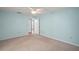 Bedroom with plush carpeting, ceiling fan, and a doorway to the rest of the home at 5618 Rosewall Cir, Leesburg, FL 34748
