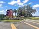 The entrance sign of Highland Lakes is surrounded by lush greenery under a beautiful blue sky at 5618 Rosewall Cir, Leesburg, FL 34748