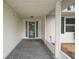 Inviting entryway featuring a blue glass paneled front door and a covered porch area at 5618 Rosewall Cir, Leesburg, FL 34748