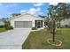 Charming single-story home featuring a two-car garage, screened front porch, and well-maintained landscaping at 5618 Rosewall Cir, Leesburg, FL 34748