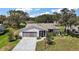 Charming home featuring an attached two-car garage, screened in porch, and well-manicured landscaping at 5618 Rosewall Cir, Leesburg, FL 34748