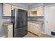 Modern kitchen featuring a stainless steel refrigerator and classic cabinetry, offering ample storage at 5618 Rosewall Cir, Leesburg, FL 34748