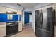 Spacious kitchen with stainless steel refrigerator and gas range, perfect for cooking and entertaining at 5618 Rosewall Cir, Leesburg, FL 34748