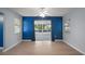 Open living area with wood floors, bright paint, and sliding door access to the screened in patio at 5618 Rosewall Cir, Leesburg, FL 34748