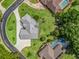 Aerial view showcases home's manicured lawn, long driveway, and neighborhood, highlighting its desirable location and landscaping at 563 Dowling Cir, Lady Lake, FL 32159