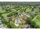 Aerial view of the property showcasing lush greenery, golf course views, and a well-defined lot line at 563 Dowling Cir, Lady Lake, FL 32159
