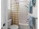 Shower and toilet area with tub and shower curtain and blue towels hanging on the towel rack at 563 Dowling Cir, Lady Lake, FL 32159