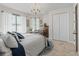 Inviting bedroom featuring neutral walls, chandelier, and plush textiles with an abundance of natural light at 563 Dowling Cir, Lady Lake, FL 32159