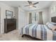 Bedroom with ceiling fan, tile floors, large window and chest of drawers at 563 Dowling Cir, Lady Lake, FL 32159