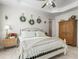 This cozy bedroom includes a wooden bed frame, white bedding, and a tray ceiling at 563 Dowling Cir, Lady Lake, FL 32159
