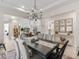 Open dining room showcasing a large table, seating for eight, a chandelier, and views into other living spaces at 563 Dowling Cir, Lady Lake, FL 32159