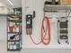 Well organized three car garage featuring overhead and wall-mounted storage racks, and epoxy floors at 563 Dowling Cir, Lady Lake, FL 32159