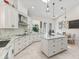 Spacious kitchen with stainless steel appliances, tile backsplash, and a center island perfect for entertaining at 563 Dowling Cir, Lady Lake, FL 32159