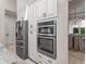 Modern kitchen with stainless steel appliances, custom cabinets, and ample storage space at 563 Dowling Cir, Lady Lake, FL 32159