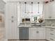 Elegant kitchen with white cabinetry, a breakfast bar, and stainless steel appliances at 563 Dowling Cir, Lady Lake, FL 32159