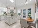 Bright kitchen featuring white cabinetry, an island, and a breakfast nook with access to the backyard at 563 Dowling Cir, Lady Lake, FL 32159