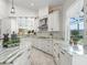 Well-lit kitchen showcasing custom cabinetry, granite countertops, a decorative backsplash, and modern stainless-steel appliances at 563 Dowling Cir, Lady Lake, FL 32159