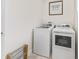 Functional laundry room with modern white washer and dryer units, with a sign reading 'Laundry Room - dry your drawers here' at 563 Dowling Cir, Lady Lake, FL 32159