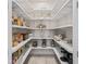 Pantry featuring extensive shelving for organized storage of food, appliances, and kitchen essentials at 563 Dowling Cir, Lady Lake, FL 32159