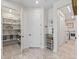 Open pantry showing ample shelving, a door to the laundry room, and a small shelf with storage baskets at 563 Dowling Cir, Lady Lake, FL 32159