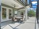 Covered patio with seating area, ceiling fan, and access to the backyard, ideal for outdoor living and entertaining at 563 Dowling Cir, Lady Lake, FL 32159