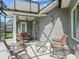 Screened-in patio with comfortable seating area, perfect for relaxing and enjoying the outdoor ambiance and weather at 563 Dowling Cir, Lady Lake, FL 32159