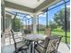 Covered patio featuring a tile-topped table with seating, perfect for enjoying outdoor meals with a view of the backyard at 563 Dowling Cir, Lady Lake, FL 32159