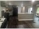 Open-concept kitchen with modern island, stainless steel appliances, and seamless flow to the living area at 606 Hamilton Dr, Orlando, FL 32833