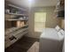 Laundry room with a washer, dryer, wire shelving, and a window at 606 Hamilton Dr, Orlando, FL 32833