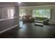 Bright and airy living room features hardwood floors, plenty of natural light, and seamless transition to kitchen at 606 Hamilton Dr, Orlando, FL 32833