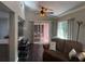 Spacious living room features a modern ceiling fan, with views to the outdoors and flows into the kitchen area at 606 Hamilton Dr, Orlando, FL 32833