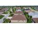 Aerial view of a residential neighborhood featuring well-maintained homes and lush green landscaping at 627 Leeds Pl, The Villages, FL 32162