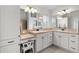 Well-lit bathroom features double sinks, white cabinets and drawers, and vanity area at 627 Leeds Pl, The Villages, FL 32162