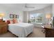 Bright bedroom featuring a sunny window, neutral carpet and a ceiling fan at 627 Leeds Pl, The Villages, FL 32162